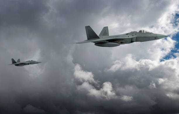 istock F-22 jet aircraft flying over clouds. 2178254575