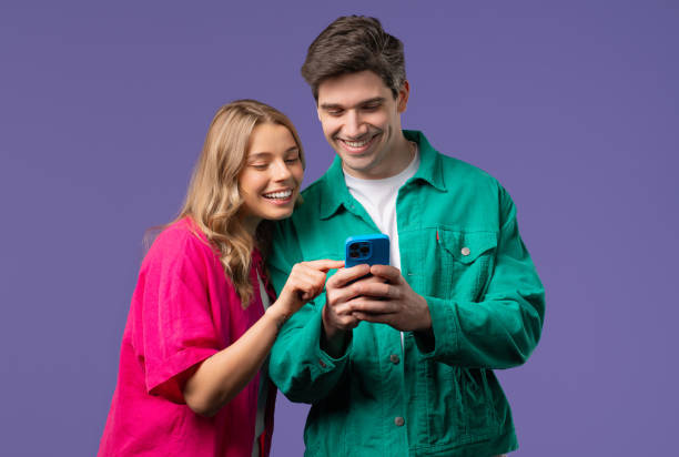 istock Young Couple Using Mobile Device. Woman Man Watching, Laughing With Smartphone 2178254677