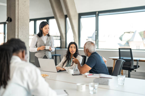 istock Diverse Executives Engage in Strategic Discussion in Modern Workspace 2178255560