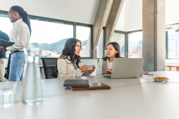 istock Diverse Executives Engage in Discussion at Modern Office Desk 2178255572