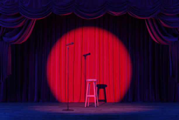 istock A stand-up stage with a microphone and spotlights. An empty theater stage with red velvet curtains. 2178256137