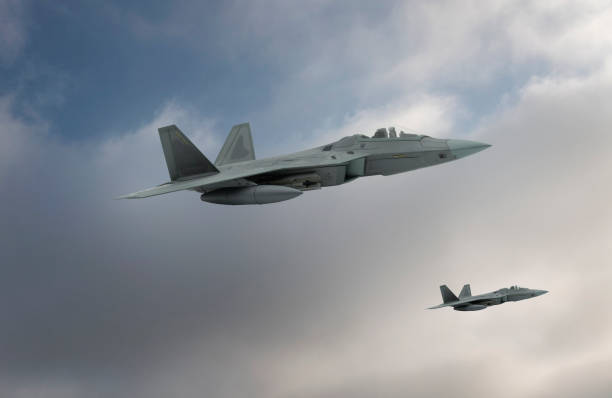 istock F-22 jet aircraft flying over clouds. 2178256369
