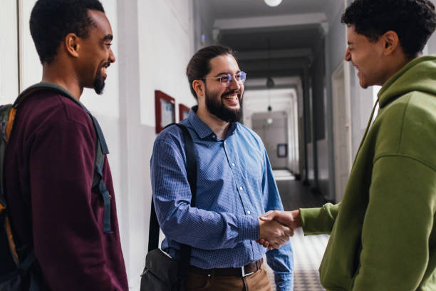 istock Three Friends Greeting Each Other with Warm Handshakes 2178258069