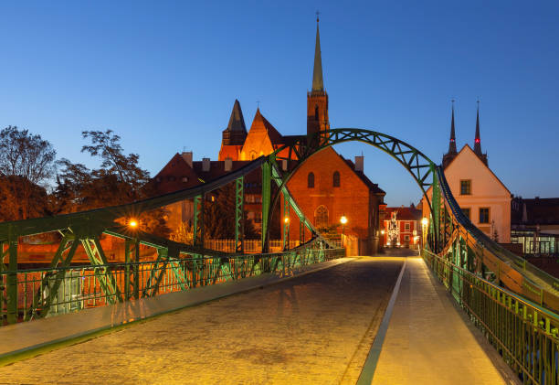 Night illuminated Tumski Bridge and Cathedral of St John the Baptist in Wroclaw, Poland