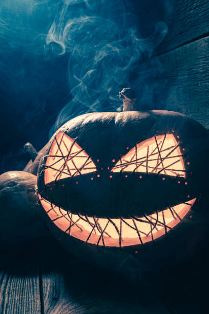 istock Spooky Halloween pumpkin with smoke and light. 2178261892