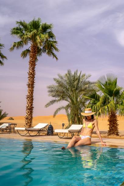istock Woman relaxing by a pool in a desert resort. 2178265516