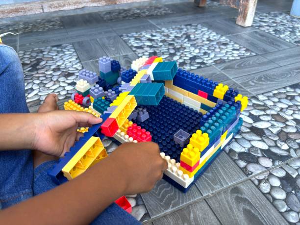 istock A child's hand is holding a toy 2178265978