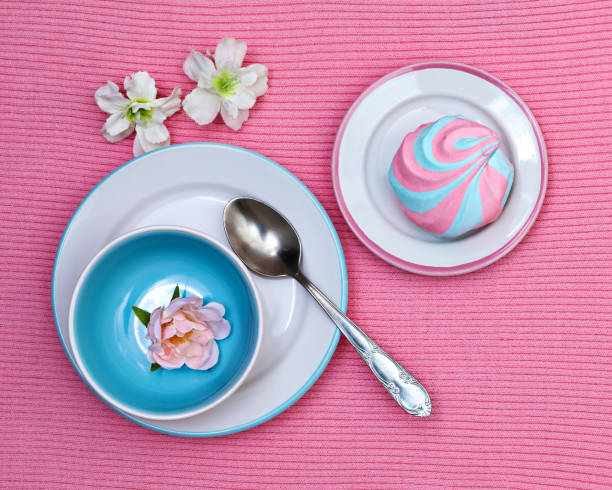 istock Colorful fluffy marshmallow on saucers on a pink knitted background 2178266165