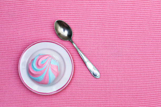 istock Colorful fluffy marshmallow on saucers on a pink knitted background 2178266170