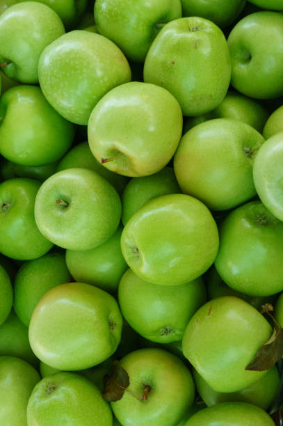 istock green apples background in a close-up display at a market 2178266251