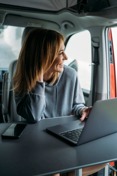 istock Blonde woman looking out van window 2178266376