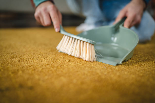 istock Close up of man hands clean carpet with a broom 2178267925