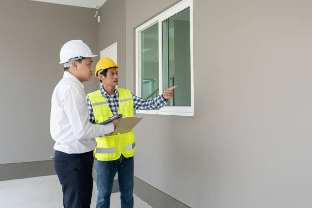 istock inspector engineer and owner project is inspecting construction and quality assurance new house. Engineers or architects or contactor work to build the house before handing it over to the homeowner 2178272212