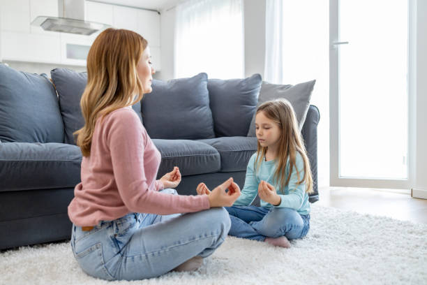 istock Peaceful mother and daughter meditation at home 2178273432
