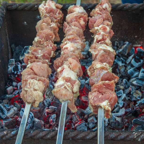 istock Three skewers with marinated meat on the grill 2178273874