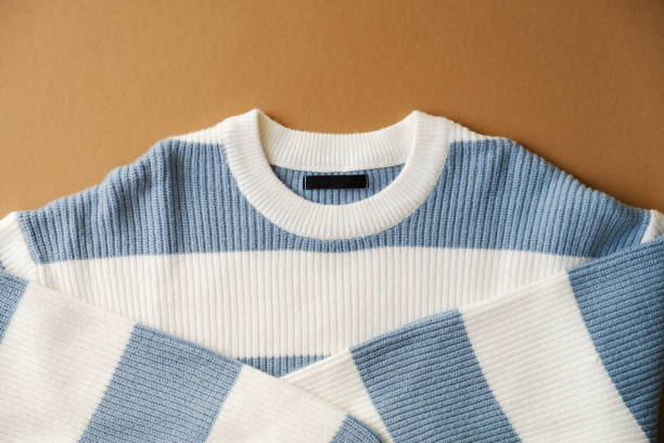 istock Stylish blue and white striped sweater on brown background 2178273888