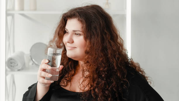 istock Water diet weight loss hydration woman with glass 2178274371