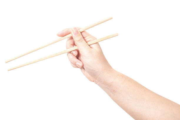 istock Female hand holding a wood chopstick isolated on white background. 2178275191