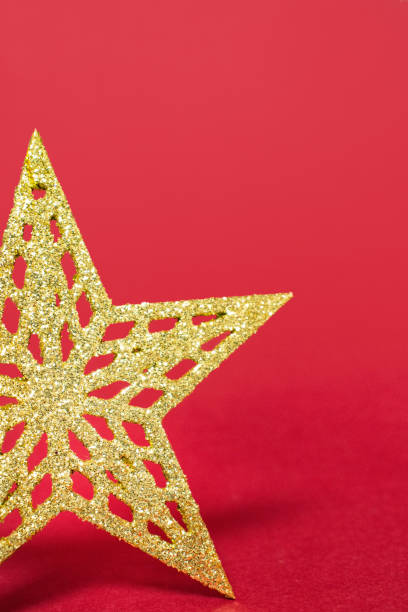 A close-up of a soft white star ornament resting on a sparkling, iridescent surface with scattered pearls. Warm bokeh and pastel tones create a dreamy holiday atmosphere perfect for Christmas, New Year, or festive celebration concepts.