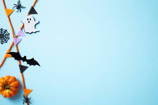 istock Happy Halloween holiday concept. Flat lay composition with bunting garland, pumpkins, ghosts, bats, spiders on blue background. Scary Halloween banner design. 2178276031