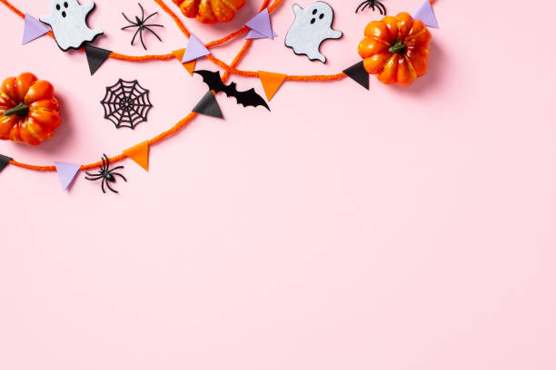 istock Happy Halloween holiday concept. Flat lay composition with pumpkins, ghosts, bats, spiders and bunting garland on pastel pink background 2178276047