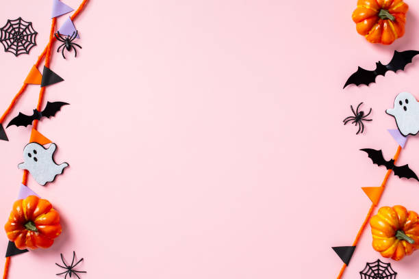 istock Happy Halloween holiday concept. Flat lay composition with pumpkins, ghosts, bats, spiders and bunting garland on pastel pink background 2178276064