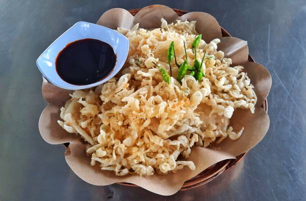 Mendoan tempeh or fried tempeh, traditional food from Banyumas, Central Java, Indonesia. Made from tempeh covered in flour batter. Suitable served with soy sauce.