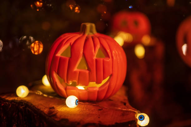 istock Halloween pumpkin lantern and eyes light with bokeh background 2178280864