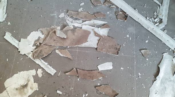 istock Ceiling fragments falling to the floor. Building damage. Earthquake effects or building roof leaks. Ceiling pieces falling. 2178292781