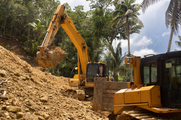 istock A working excavator is building a water supply system on a tropical island. Loose soil 2178295074