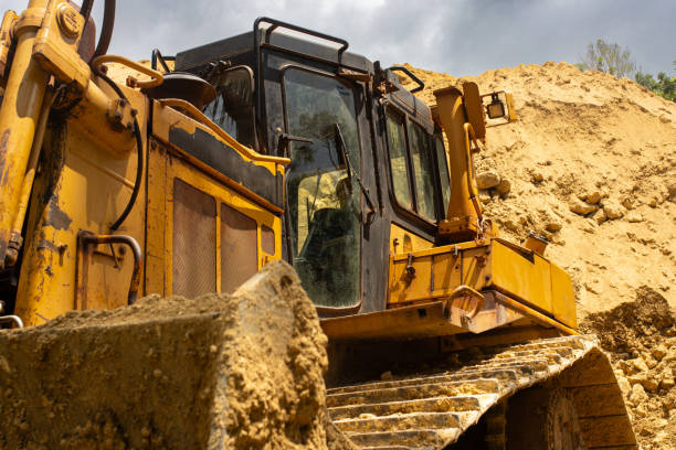 istock A bulldozer worker is building a water supply system on a tropical island. Loose soil 2178295172