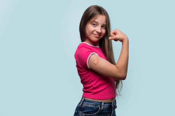 istock Girl flexing arm with bandage after vaccination 2178296569