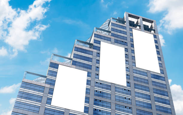 istock Mock up three white vertical large LED display billboard on tower building with blue sky background .clipping path for mockup 2178297158