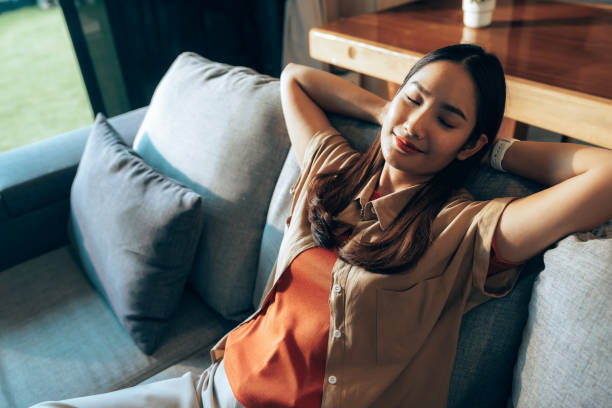 istock Gen Z Woman Enjoying Relaxation with Eyes Closed on Comfortable Couch 2178298595