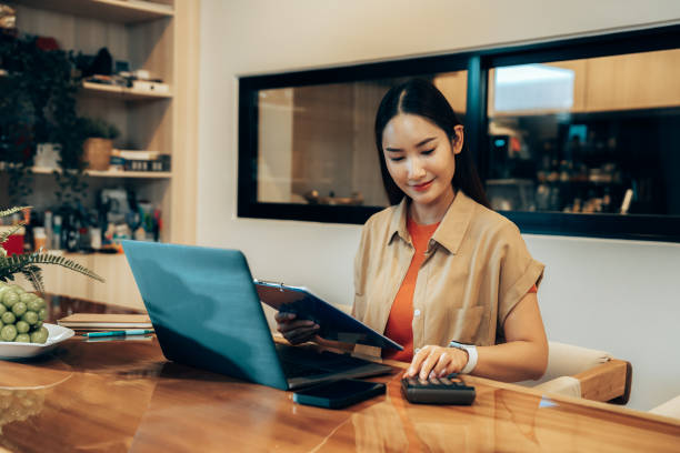 Focused Young Woman Working Remotely on Laptop in Minimalist Workspace