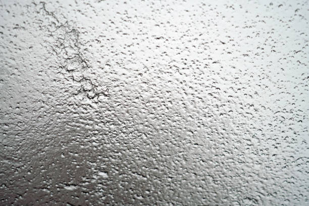 Frozen rain on the glass of car window