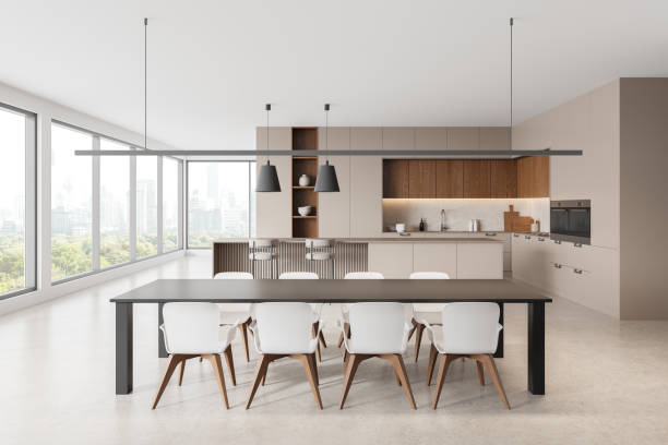 istock Beige home kitchen interior with dining table, bar counter, cabinet near window 2178300864