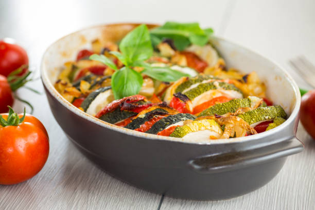 istock prepared baked zucchini and tomatoes in circles in a ceramic form, vegetable snack 2178300918