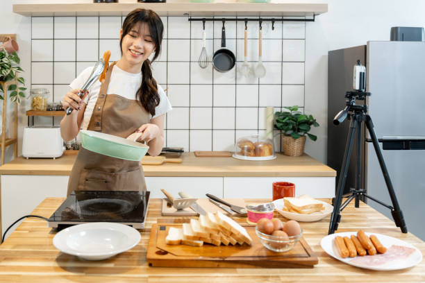 istock An Asian woman is making breakfast content for her followers. 2178300995