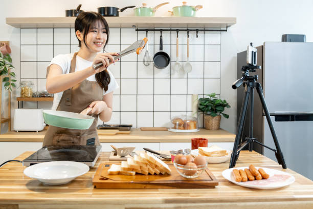 istock An Asian woman is making breakfast content for her followers. 2178301190
