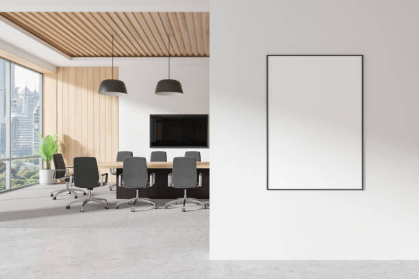 istock Blank poster frame mockup displayed on a white wall in a modern office space with a conference table and chairs, wooden ceiling, and large windows. 3D Rendering 2178301726
