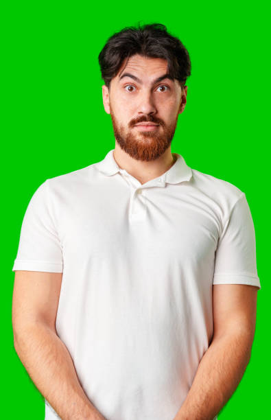 istock A man with a serious expression stands against a vibrant green background 2178303347