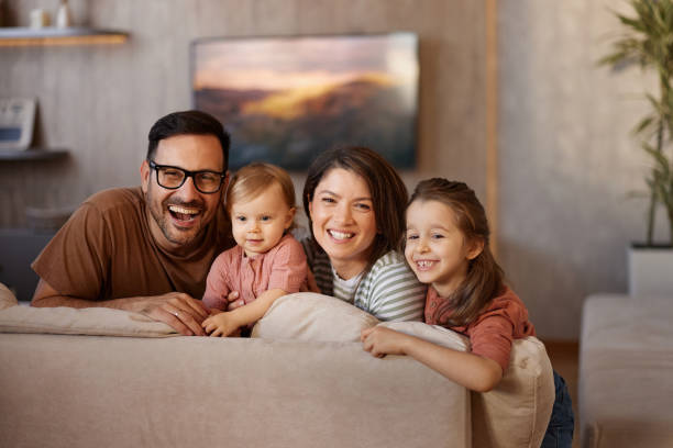 istock Happy family enjoying on sofa at home. 2178304080