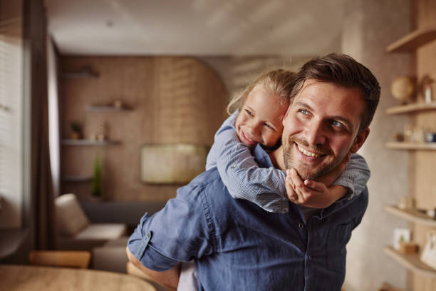 istock Happy father piggybacking his daughter at home. 2178304291