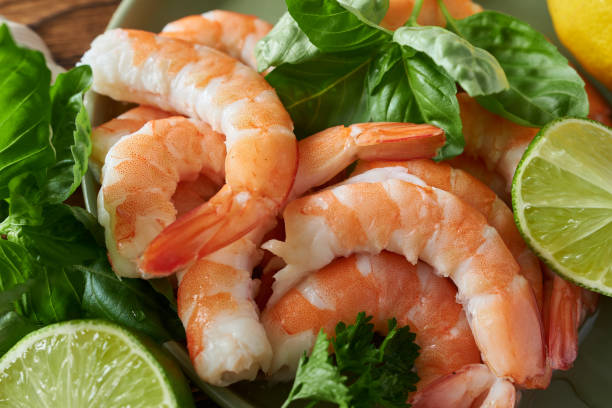istock Shrimps with lime and herbs on plate, close-up 2178304343