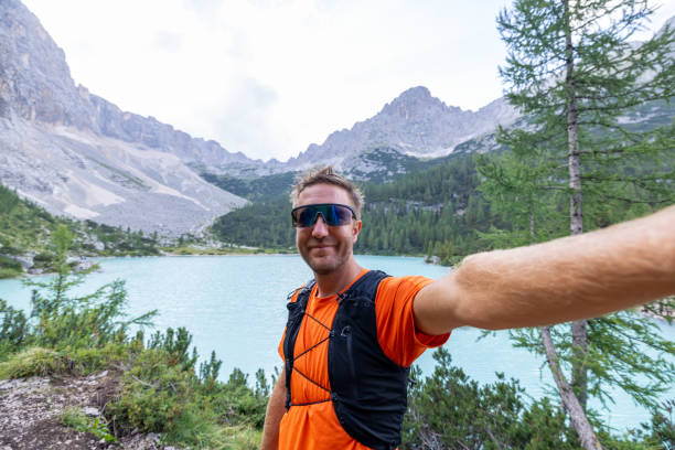 istock Man Taking Selfie by Turquoise Mountain Lake and Rocky Peaks 2178305290