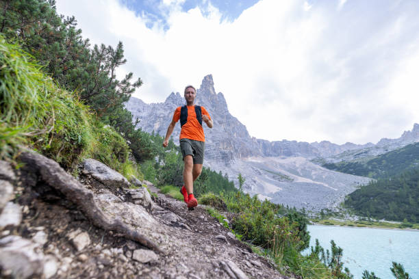istock Man Trail Running by Turquoise Mountain Lake 2178305399