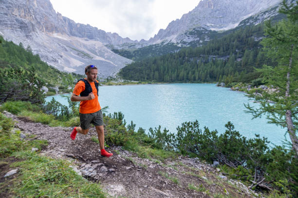 istock Man Trail Running by Turquoise Mountain Lake 2178305420
