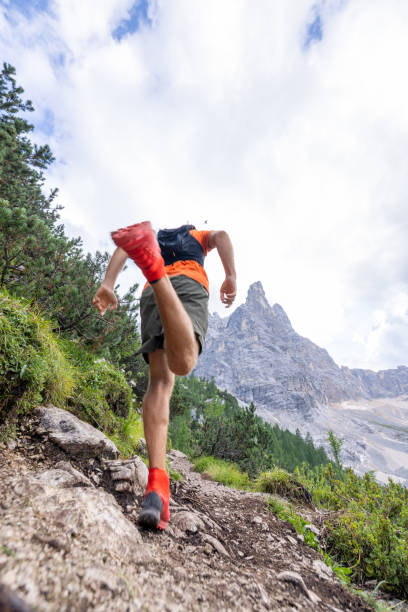 istock Man Trail Running Up Mountain Path with Rocky Peaks 2178305463