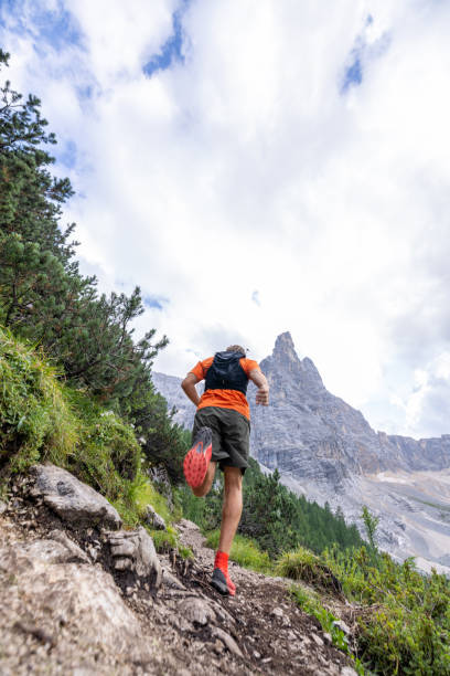 istock Man Trail Running Up Mountain Path with Rocky Peaks 2178305476
